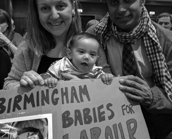Eltern mit Baby und Schild "Birmingham Babies vor Labour"